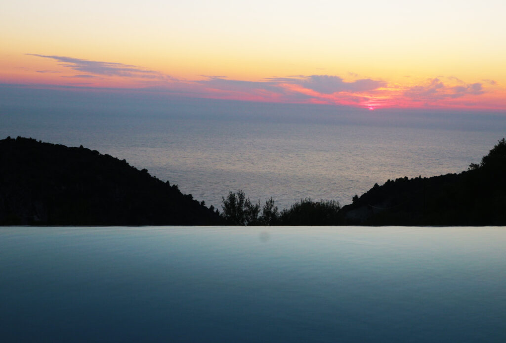 Photo of the infinity pool and sea view during sun set